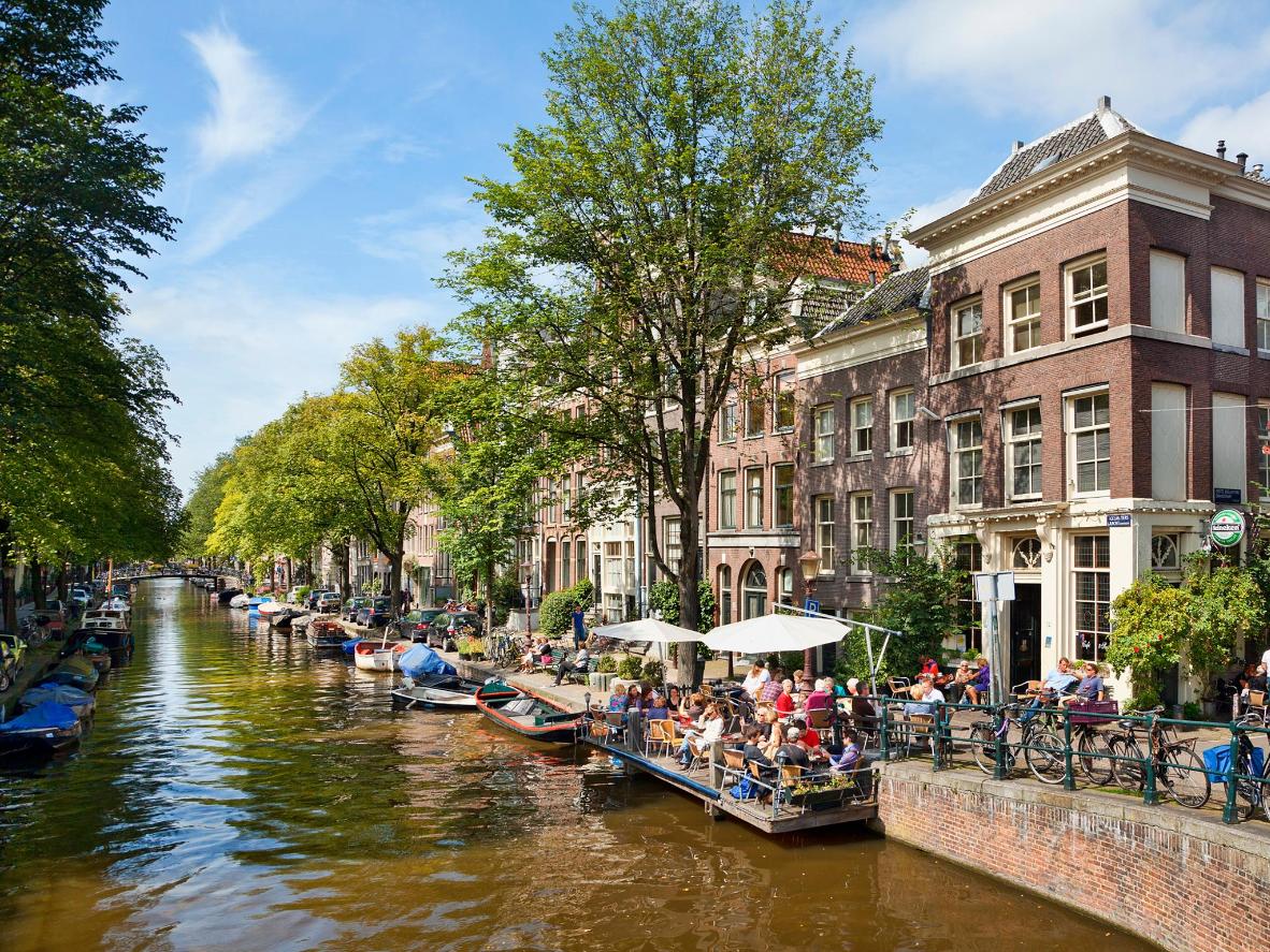 Summer is the perfect time to sit by the canals in Amsterdam, Netherlands